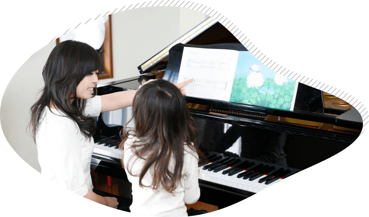 子供にピアノを教える女性